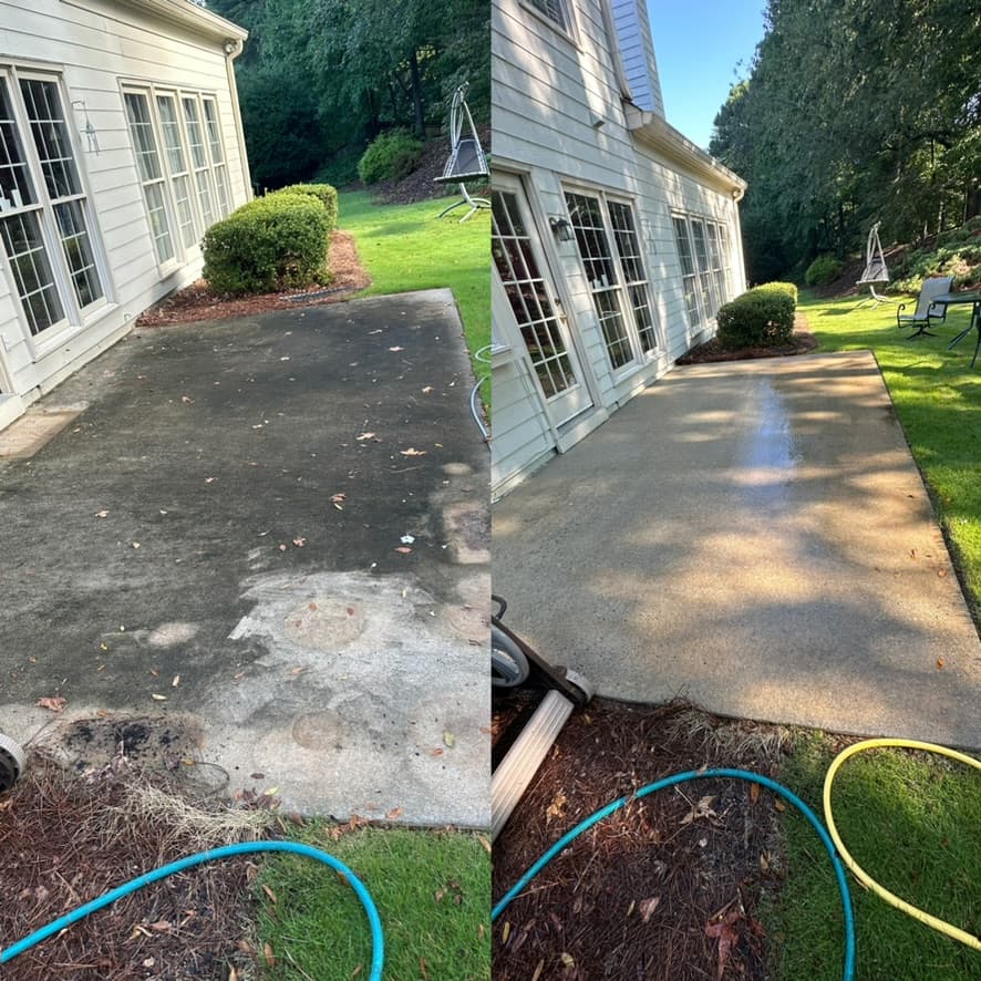 Backyard concrete patio half covered in dark algae and grime, then bright and uniform after pressure washing