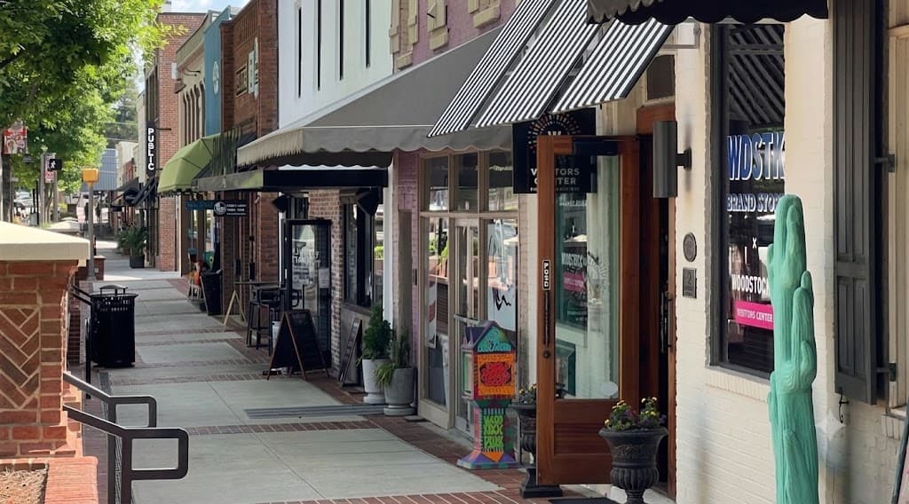 Downtown Woodstock's lively main street storefronts on a sunny afternoon