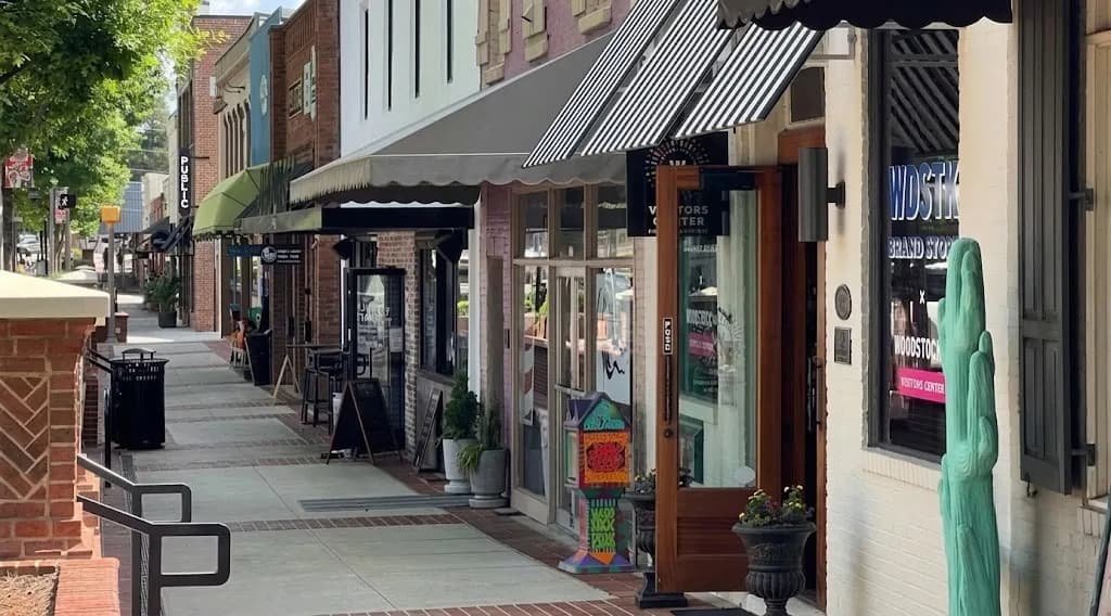 Downtown Woodstock's lively main street storefronts on a sunny afternoon