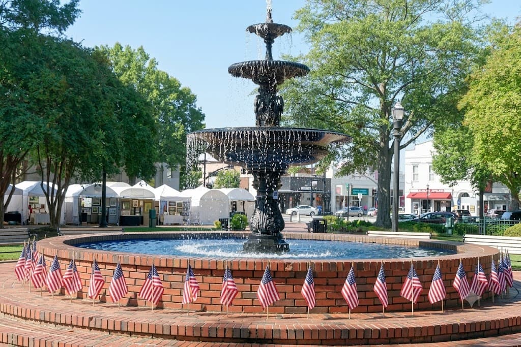 Historic Marietta Square with the Glover Park bandstand and brick storefronts at golden hour