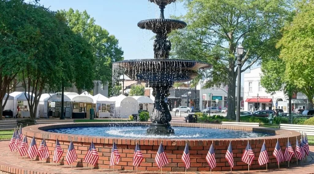 Historic Marietta Square with the Glover Park bandstand and brick storefronts at golden hour